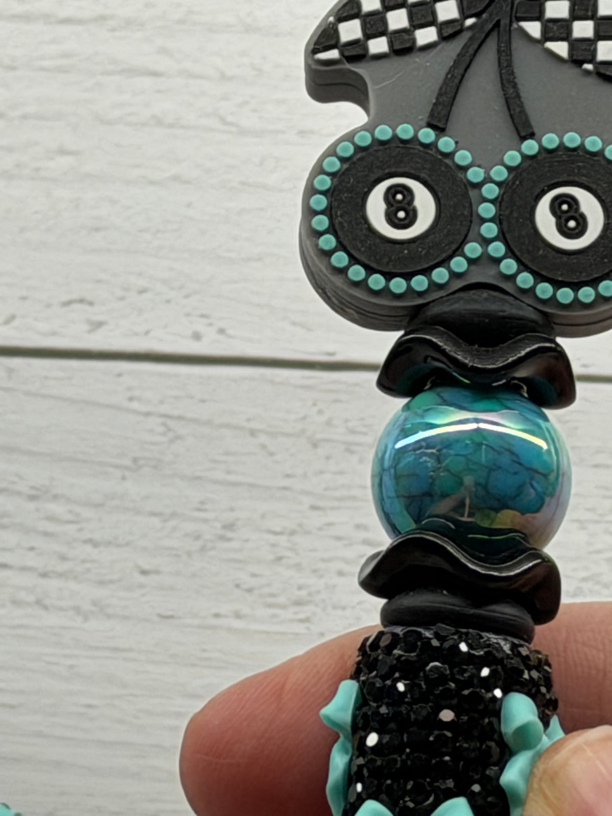 Eight ball cherries on a turquoise bows on black rhinestones
