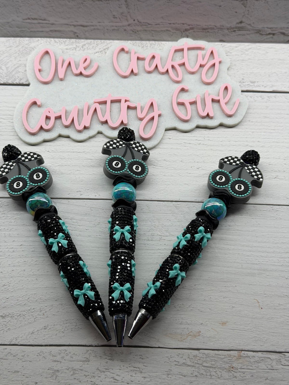 Eight ball cherries on a turquoise bows on black rhinestones