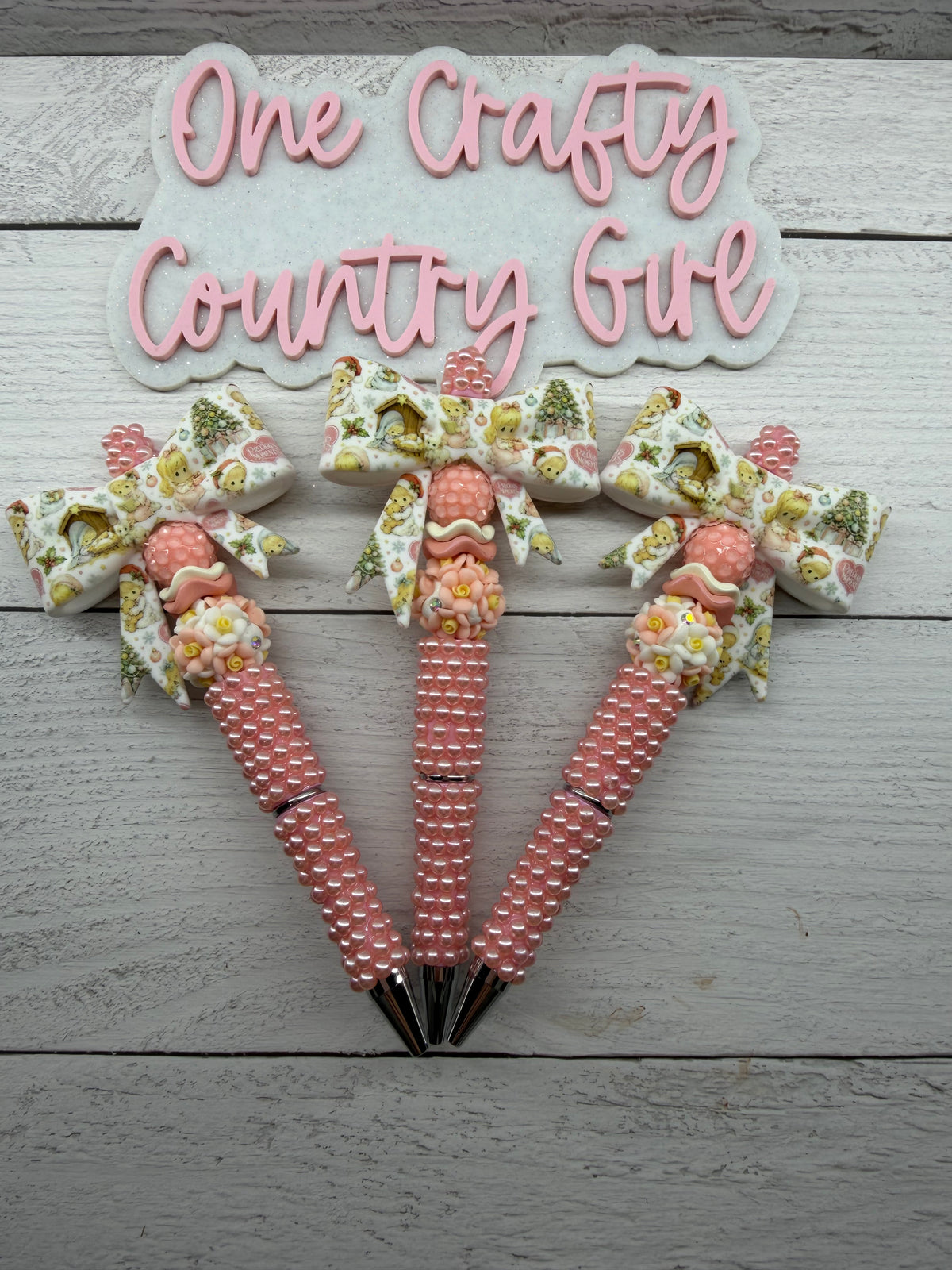 Precious Moments inspired bow on a peach pearl pen.