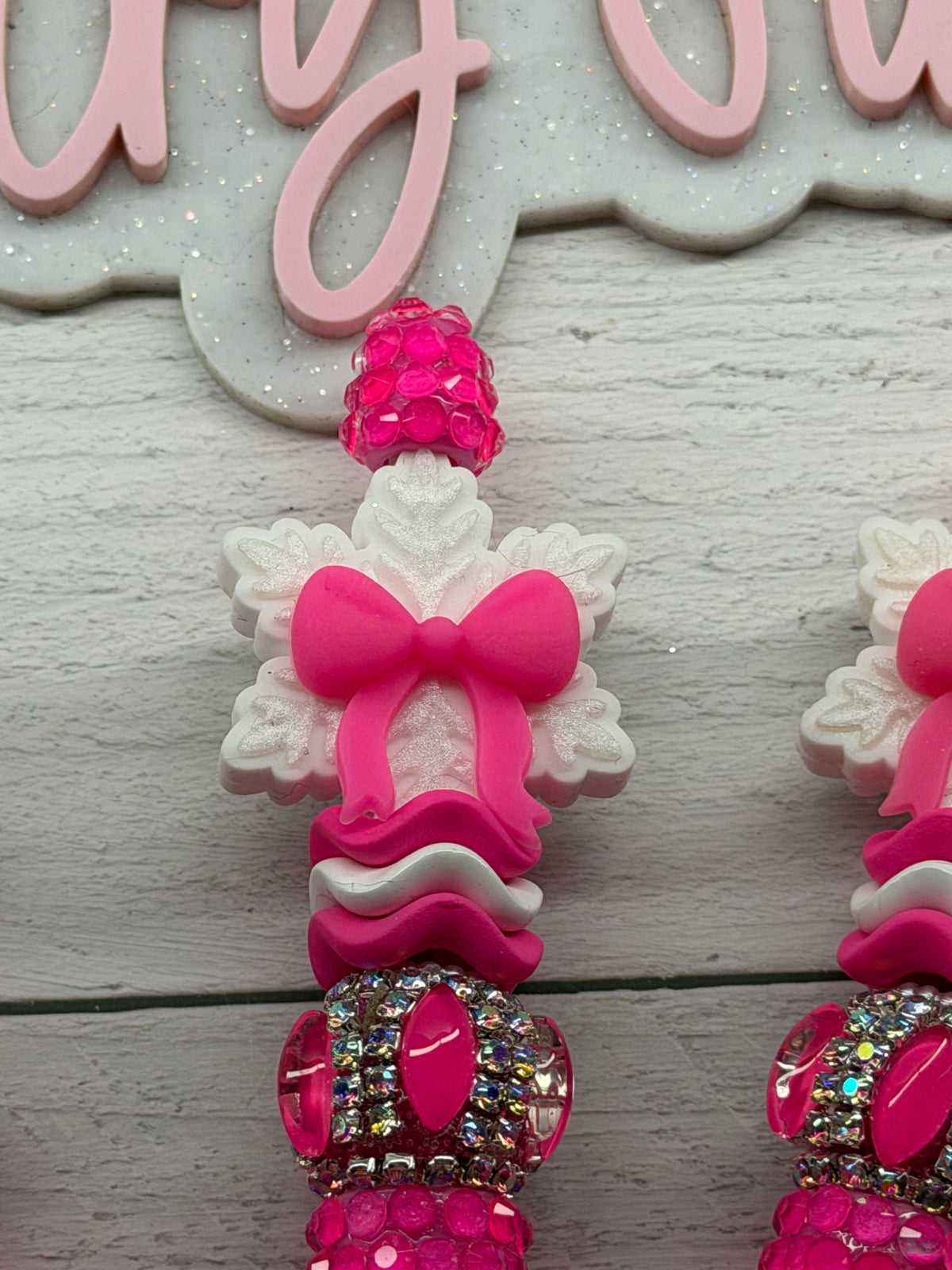 Bright pink snowflake bow on a bright pink pen