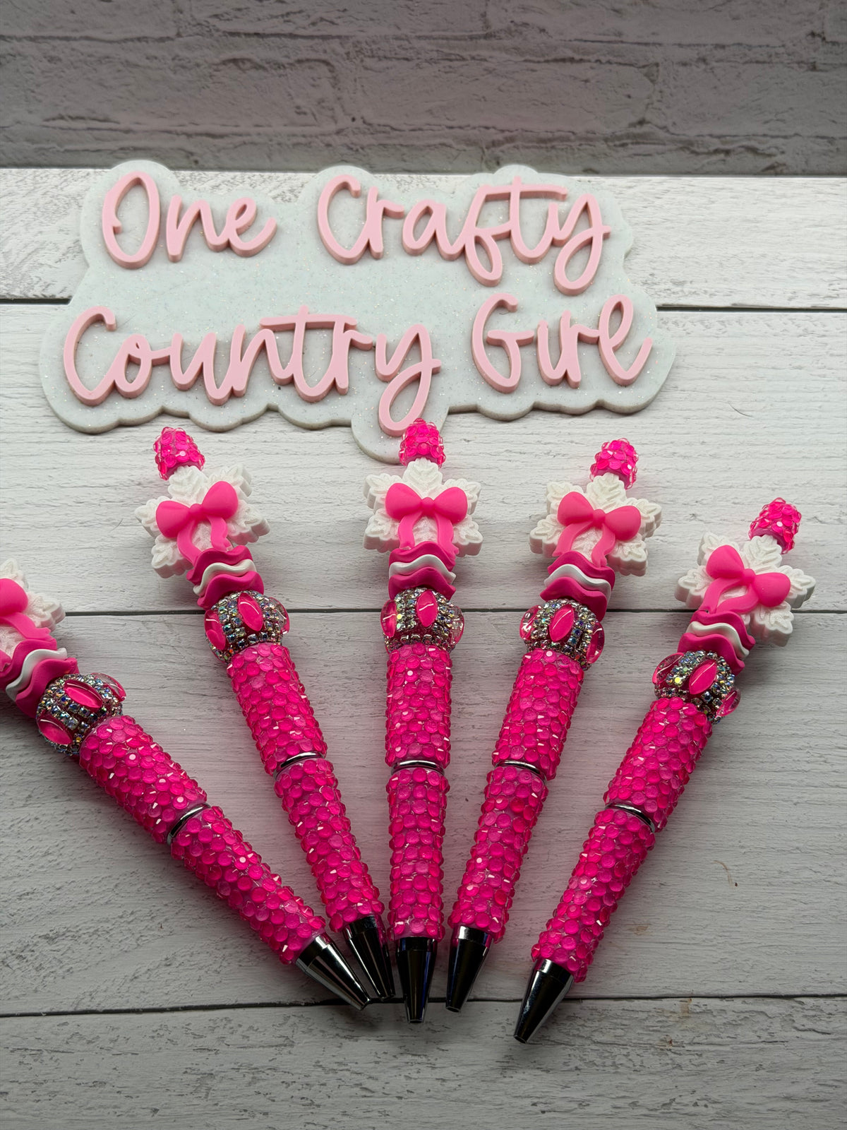 Bright pink snowflake bow on a bright pink pen
