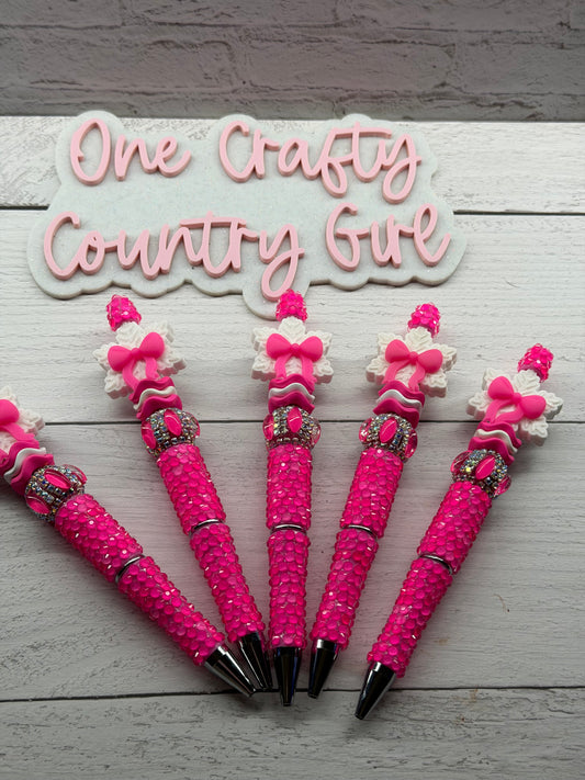 Bright pink snowflake bow on a bright pink pen