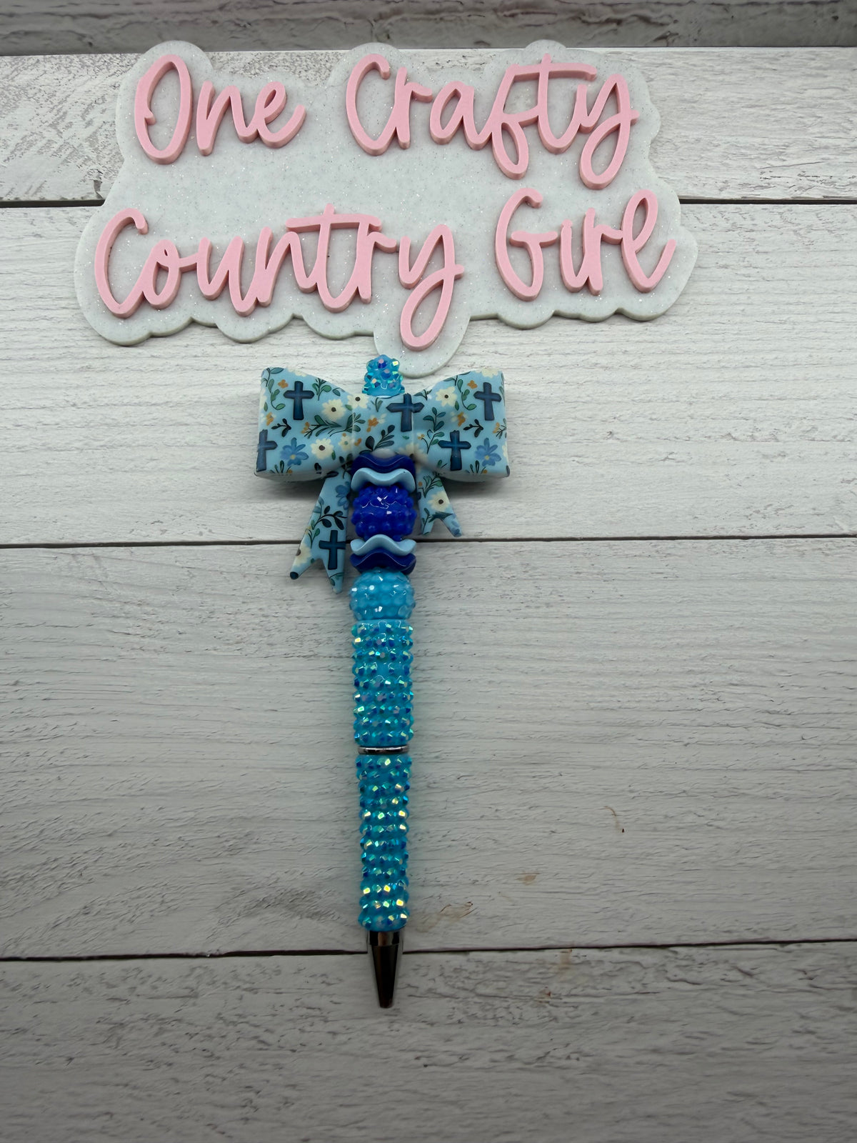 Blue cross and flowers bow on rhinestone pen