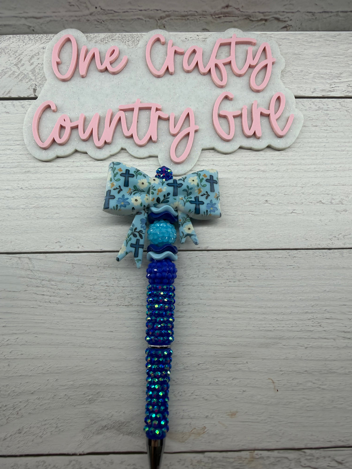 Blue cross and flowers bow on rhinestone pen