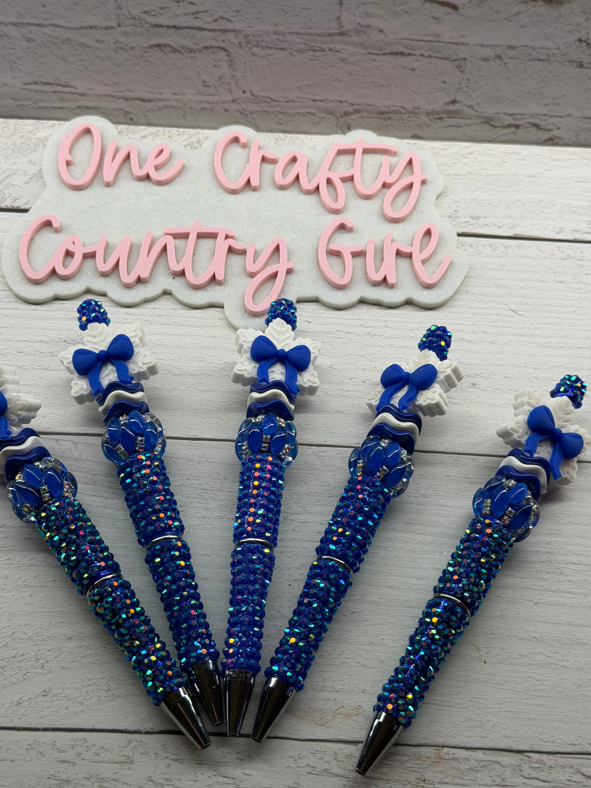 Royal blue bow snowflake on blue rhinestone pen
