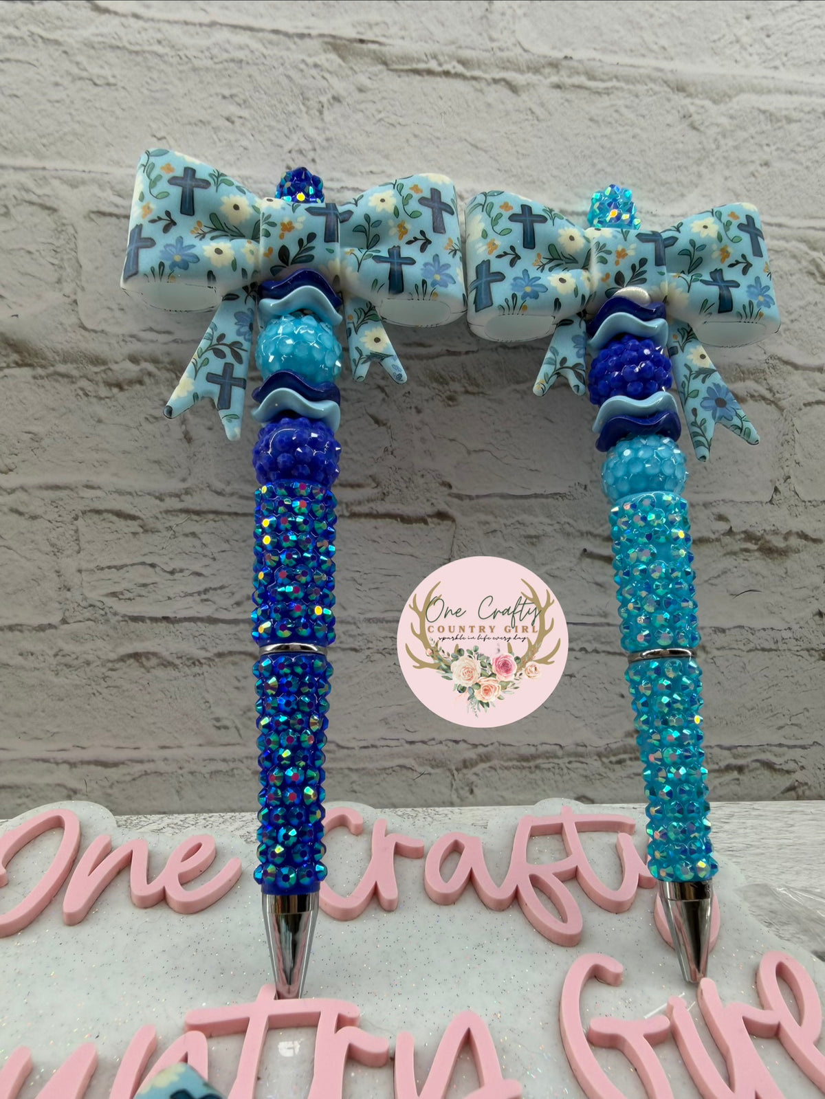 Blue cross and flowers bow on rhinestone pen