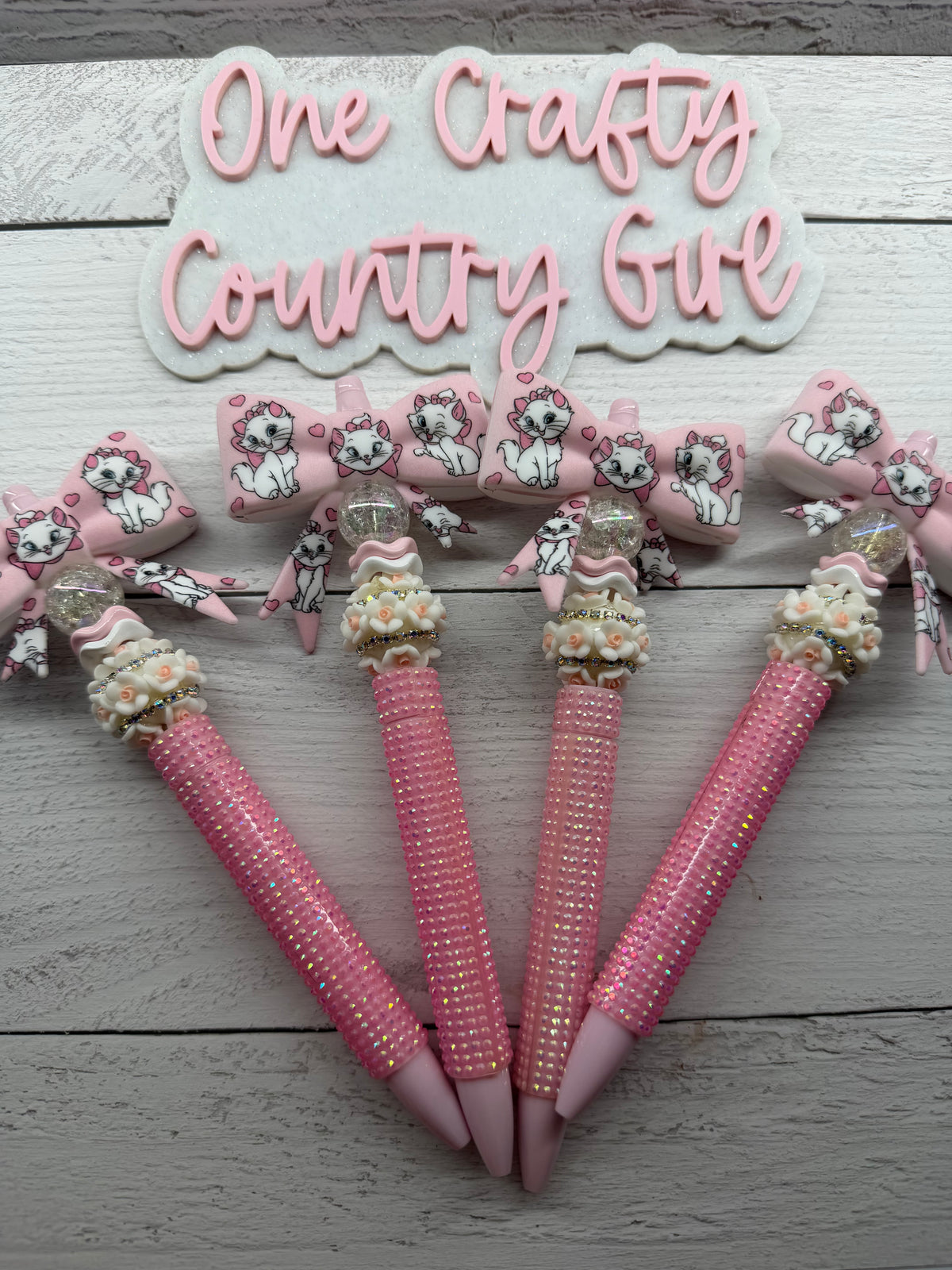 Marie inspired bows on a plastic rhinestone pen